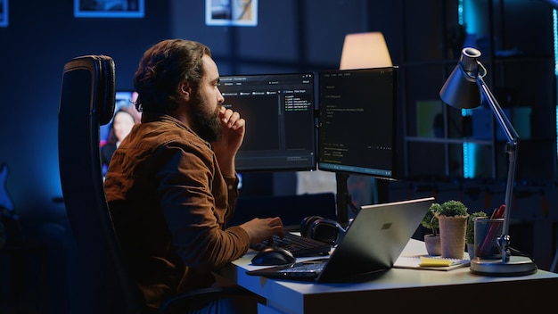 Developer typing code in home office to develop software application