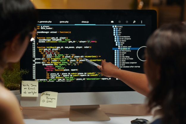 Developers pointing at programming code