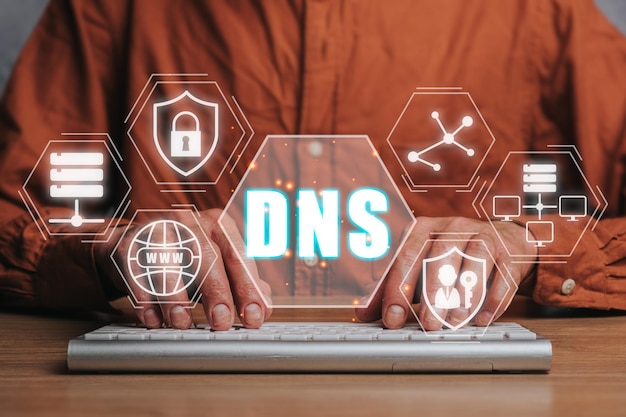 DNS Domain name System server concept Person hand typing on keyboard with domain name system server icon on virtual screen Mixed media
