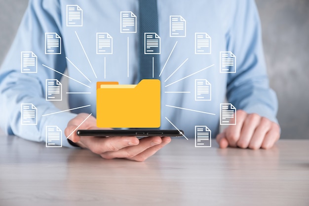 Document Management System DMS .Businessman hold folder and document icon.Software for archiving,