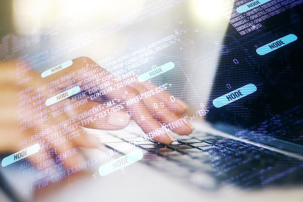 Double exposure of abstract programming language hologram with world map and hands typing on laptop on background research and development concept