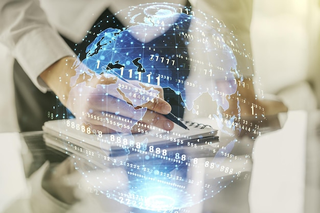 double exposure of abstract programming language with world map and man hand writing in notebook on background research and development concept