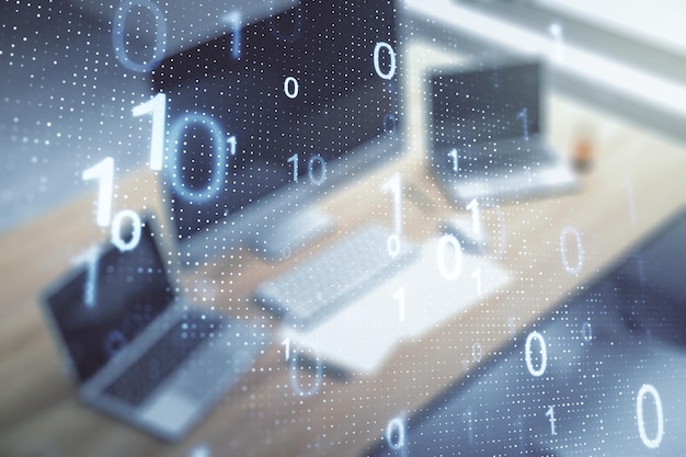 Double exposure of creative abstract binary code hologram and modern desktop with laptop on background Database and programming concept