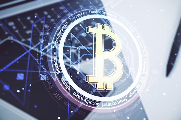 Double exposure of creative Bitcoin symbol hologram with computer on background Mining and blockchain concept