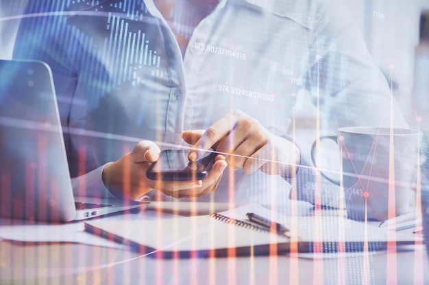 double exposure of forex chart sketch hologram and woman holding and using a mobile device financial market concept
