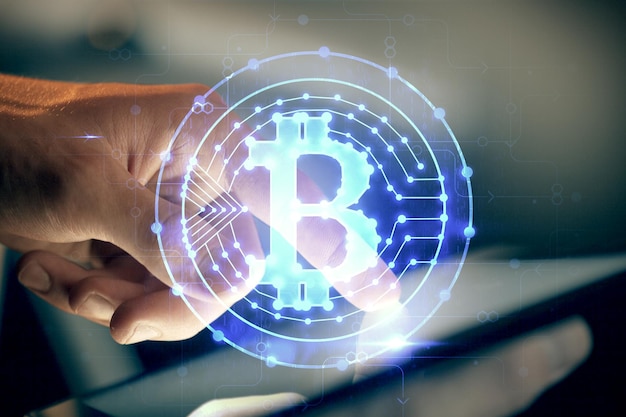 Double exposure of man's hands holding and using a phone and crypto currency blockchain theme drawing