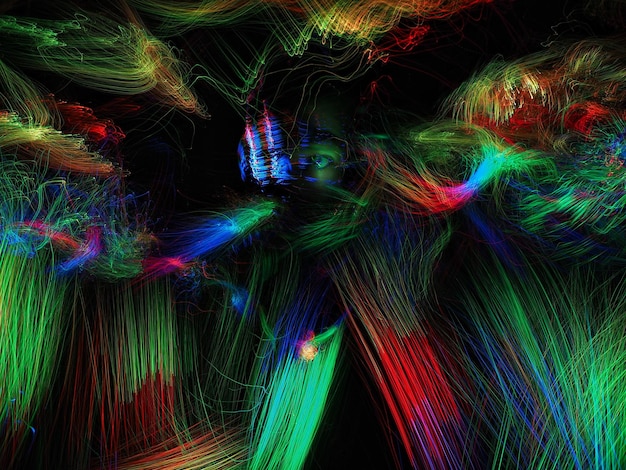 Double exposure of multi colored light trails and man over black background