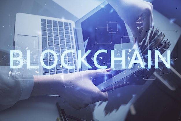 double exposure of woman hands typing on computer and crypto market theme hologram drawing blockchain concept