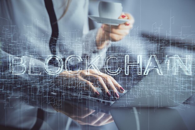 double exposure of woman hands typing on computer and crypto market theme hologram drawing blockchain concept