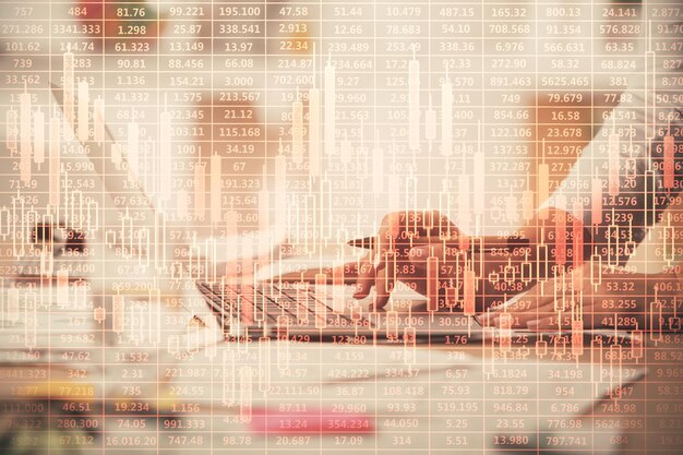double exposure of woman hands typing on computer and forex chart hologram drawing stock market invest concept
