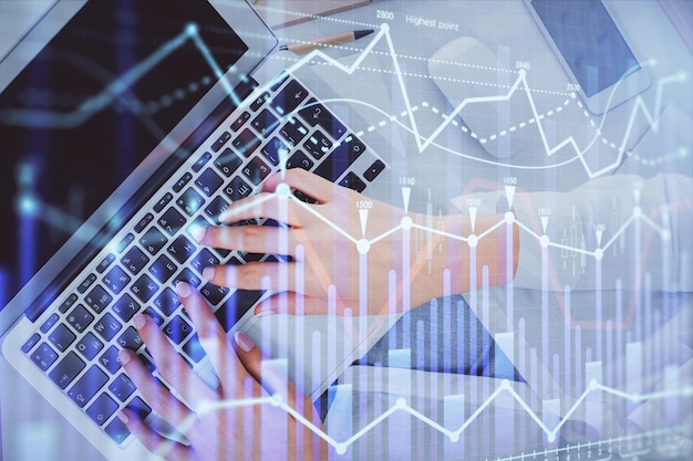 double exposure of woman hands working on computer and forex chart hologram drawing top view financial analysis concept