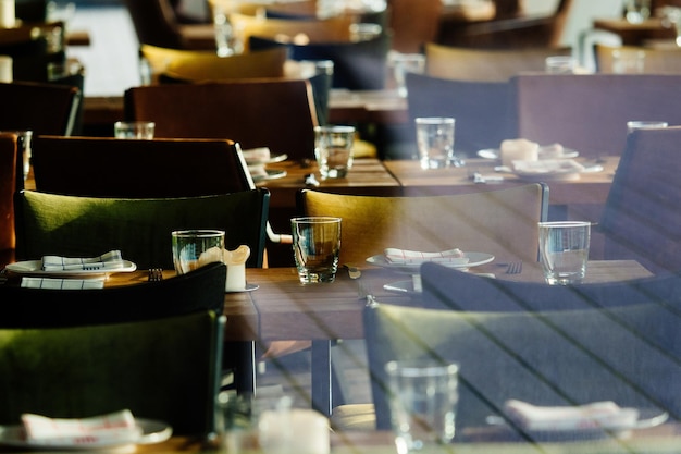 Empty chairs and tables seen through window