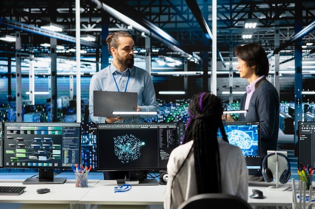 Engineers doing brainstorming in high tech data center adjusting ai model parameters to upgrade