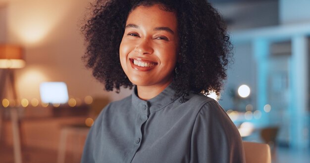 face of happy woman in office at night working on computer at international global or online internet company portrait of professional young and biracial person with career job or project mindset