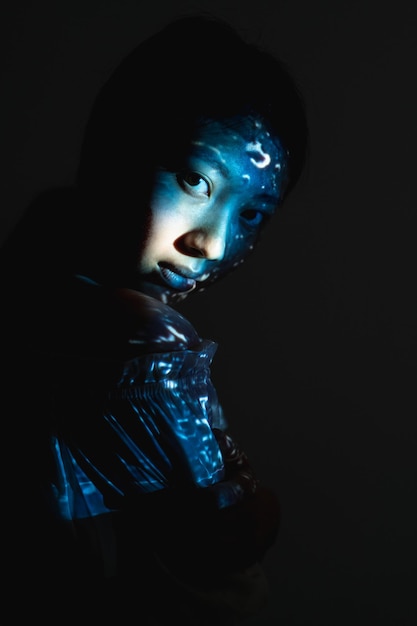 fantasy portrait spiritual beauty body art esoteric enlightenment blue asian woman face silhouette with abstract texture light isolated on black background