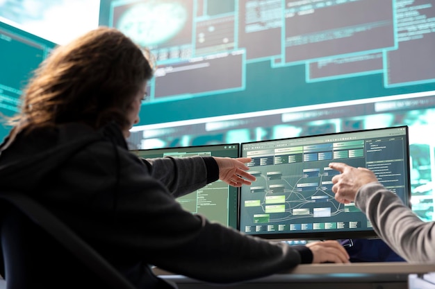 Female governmental hacker examines data on a computer in agency center