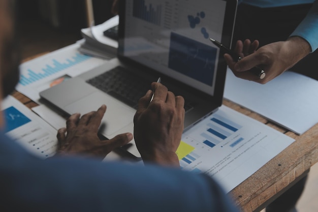 Financial analysts analyze business financial reports on a digital tablet planning investment project during a discussion at a meeting of corporate showing the results of their successful teamwork