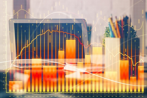 Financial chart drawing and table with computer on background Multi exposure Concept of international markets