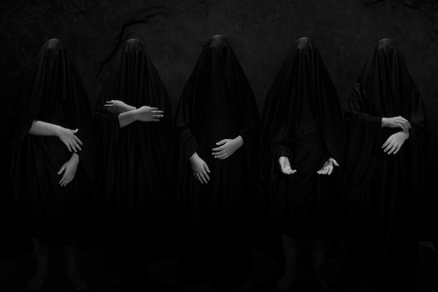 five man posed againt black background