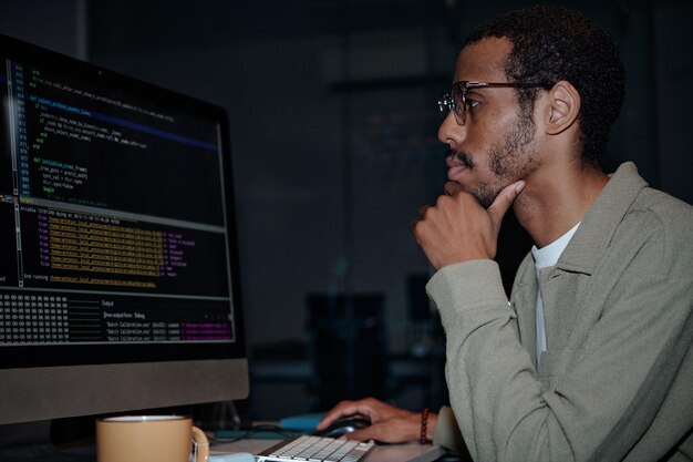 Focused Programmer Working on Code at Computer