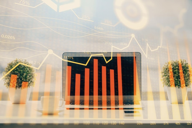 Forex Chart hologram on table with computer background Multi exposure Concept of financial markets