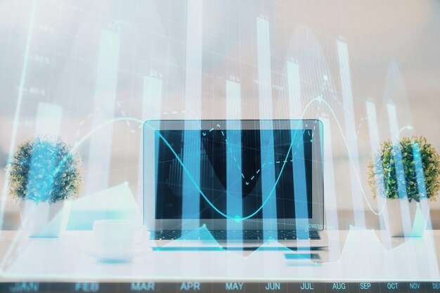Forex graph hologram on table with computer background Multi exposure Concept of financial markets