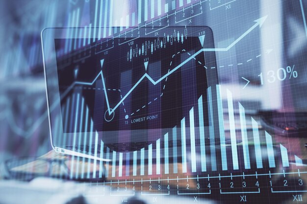 Forex market chart hologram and personal computer background Double exposure Concept of investment