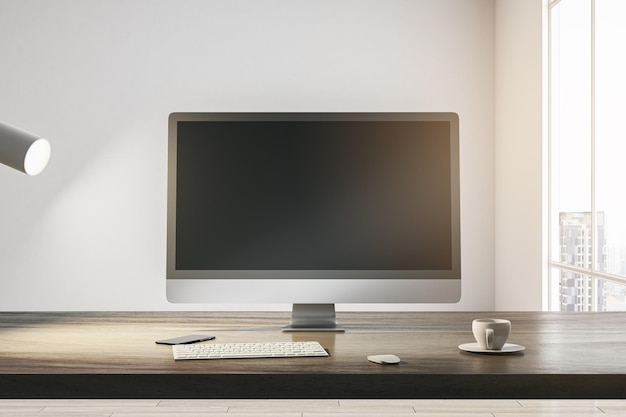 front view on blank dark modern computer monitor with place for your web site or web design on wooden table with coffee cup and keyboard on light wall background in sunlit room 3d rendering mock up
