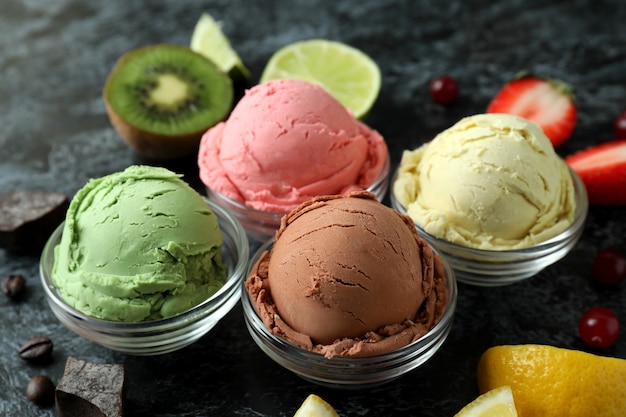 fruit ice cream and ingredients on black smokey