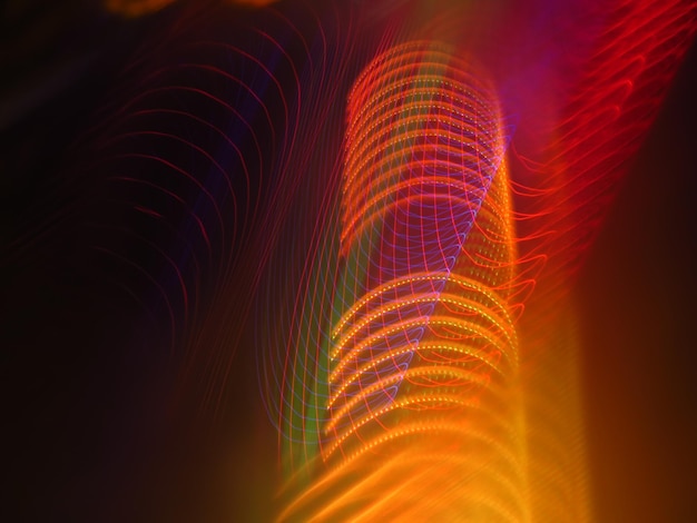 Full frame shot of illuminated light trails against black background