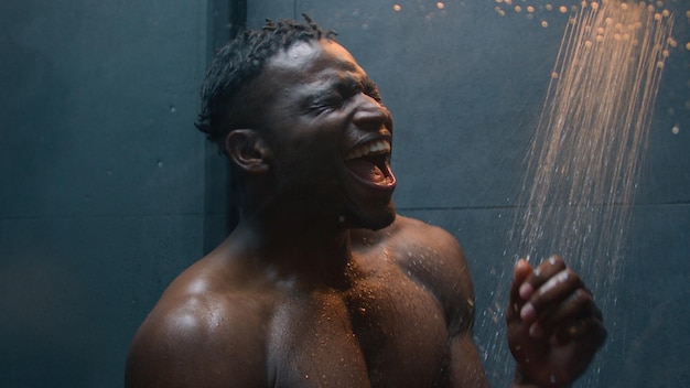 funny joyful man take shower washing body relax african american male ethnic happy guy singing song