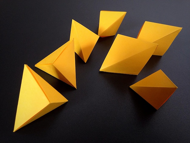 Geometric shapes made from paper on table