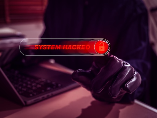 Hacker hand pressing on red warning sliding button with System Hacked text symbolizing cyberattack data breach and hacking threat Cybersecurity risk and online system compromise concept