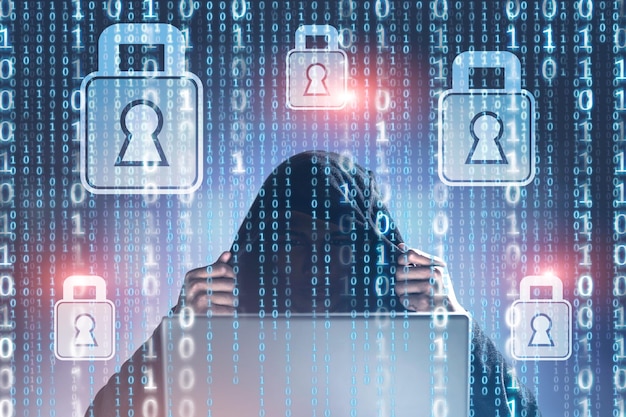 hacker in a hoodie sitting with laptop over glowing binary digits. blurred background. padlock holograms. internet security immersive interface and personal data. double exposure mock up toned image