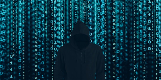 Hacker in black hood Shows the extraction through binary.