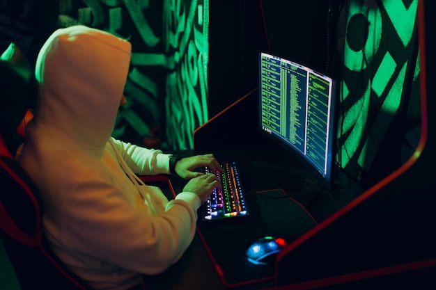 Hacker using computer malware software and hacking binary code digital interface