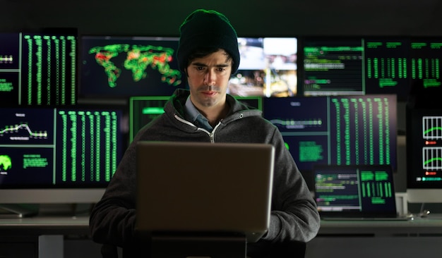 hacker using laptop breaks into government data servers and infects system with virus