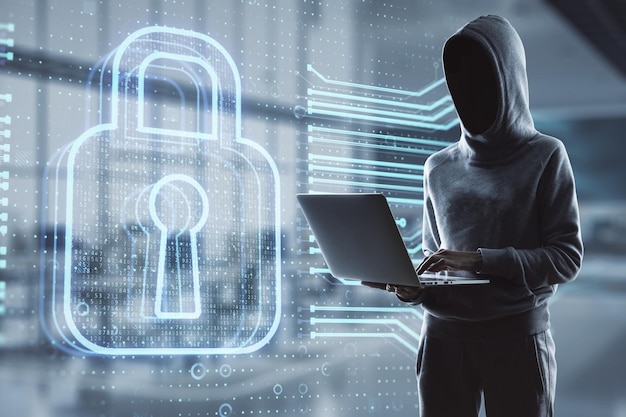 Hacker using laptop computer with abstract glowing secure web safety and protection hologram on blurry office interior background Hacking and data theft concept Double exposure