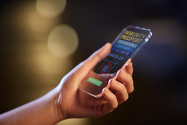 hand holding phone with certificate of vaccination