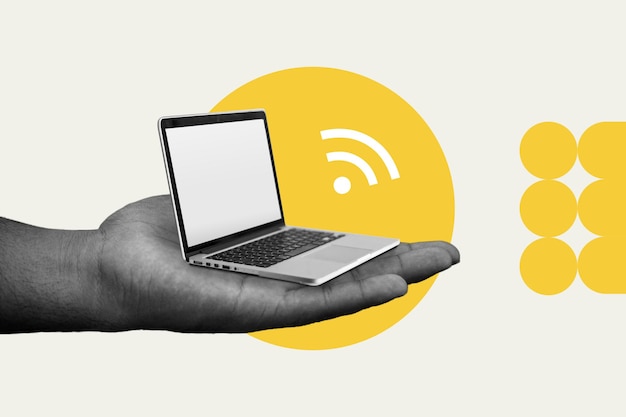 Hand holding small laptop and wifi signal symbol