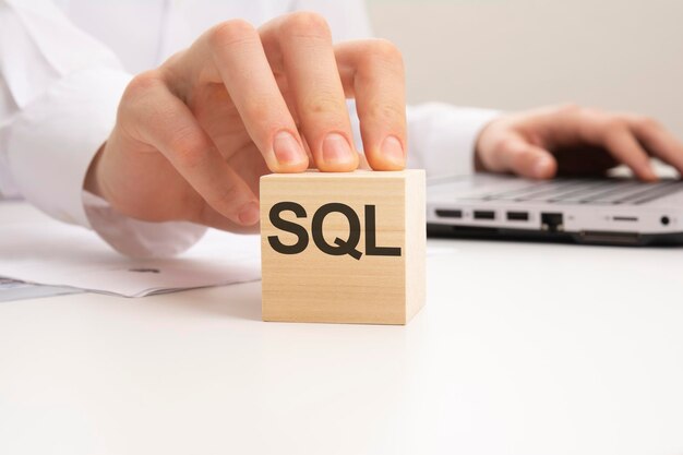 hand holding wooden block with text sql business concept