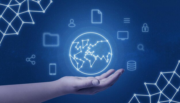 Hand holding world network concept map surrounded with internet of things icons on blue background