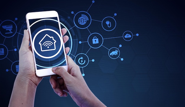 Hand of woman or man holding smartphone in house with icons in modern life internet of things
