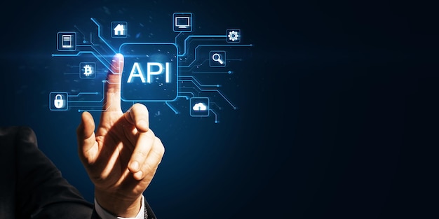 hand pointing at api icon with surrounding technology symbols on a dark blue background