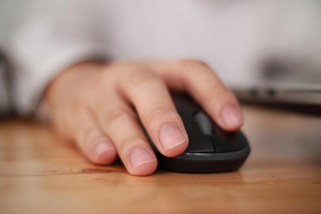 Hand using computer mouse clicking pointer laptop pc peripheral close up