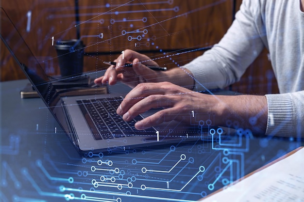 hands typing the keyboard to create innovative software to change the world and provide a completely new service close up shot hologram tech graphs concept of dev team