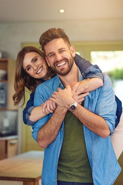 happy man woman and hug in kitchen for portrait love and romance or support at home couple together and smile in living space for trust comfort and affection in relationship and commitment