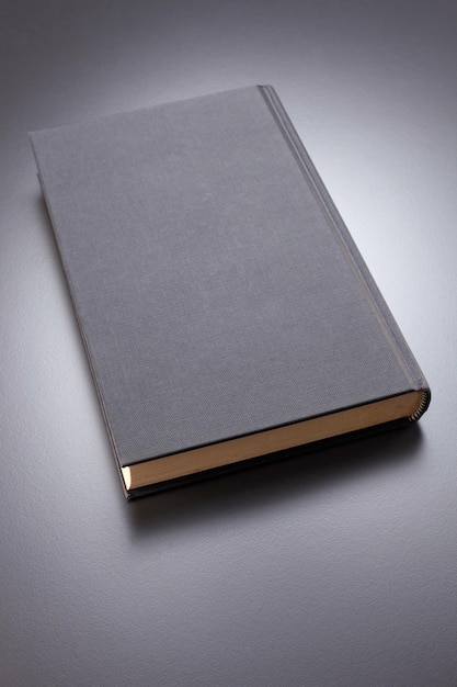 High angle view of book on table over white background