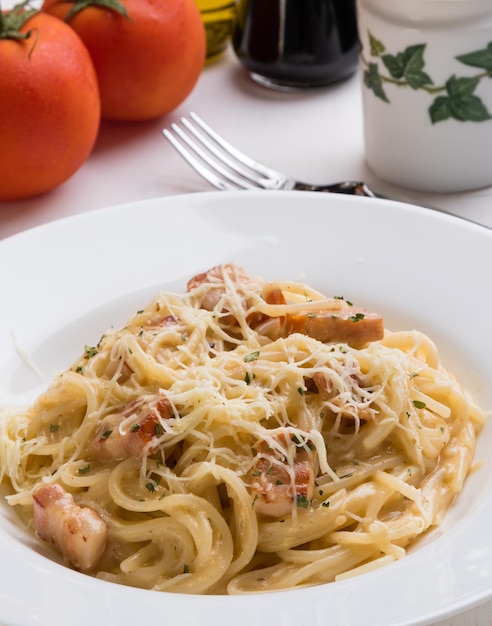 high angle view of spaghetti with carbonara in plate on table