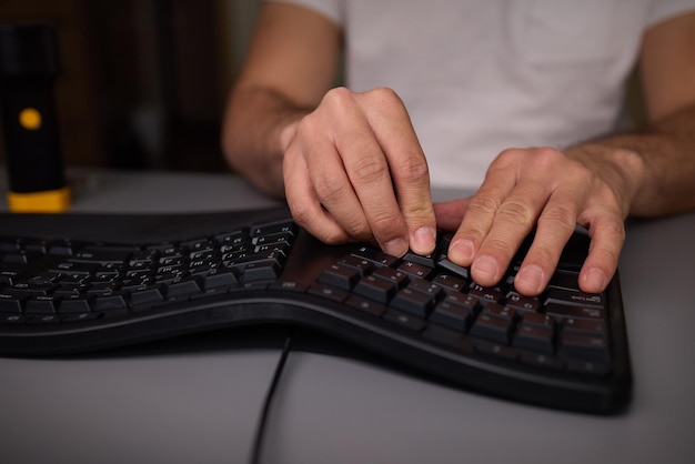 In a closeup shot a hand is seen using a keycap puller tool to meticulously remove a keyboard key